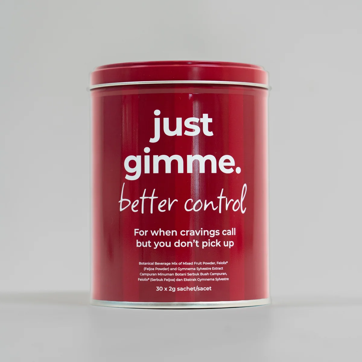 EDITED-15 Red metal canister labeled 'just gimme. better control'—a craving-control supplement on a neutral background