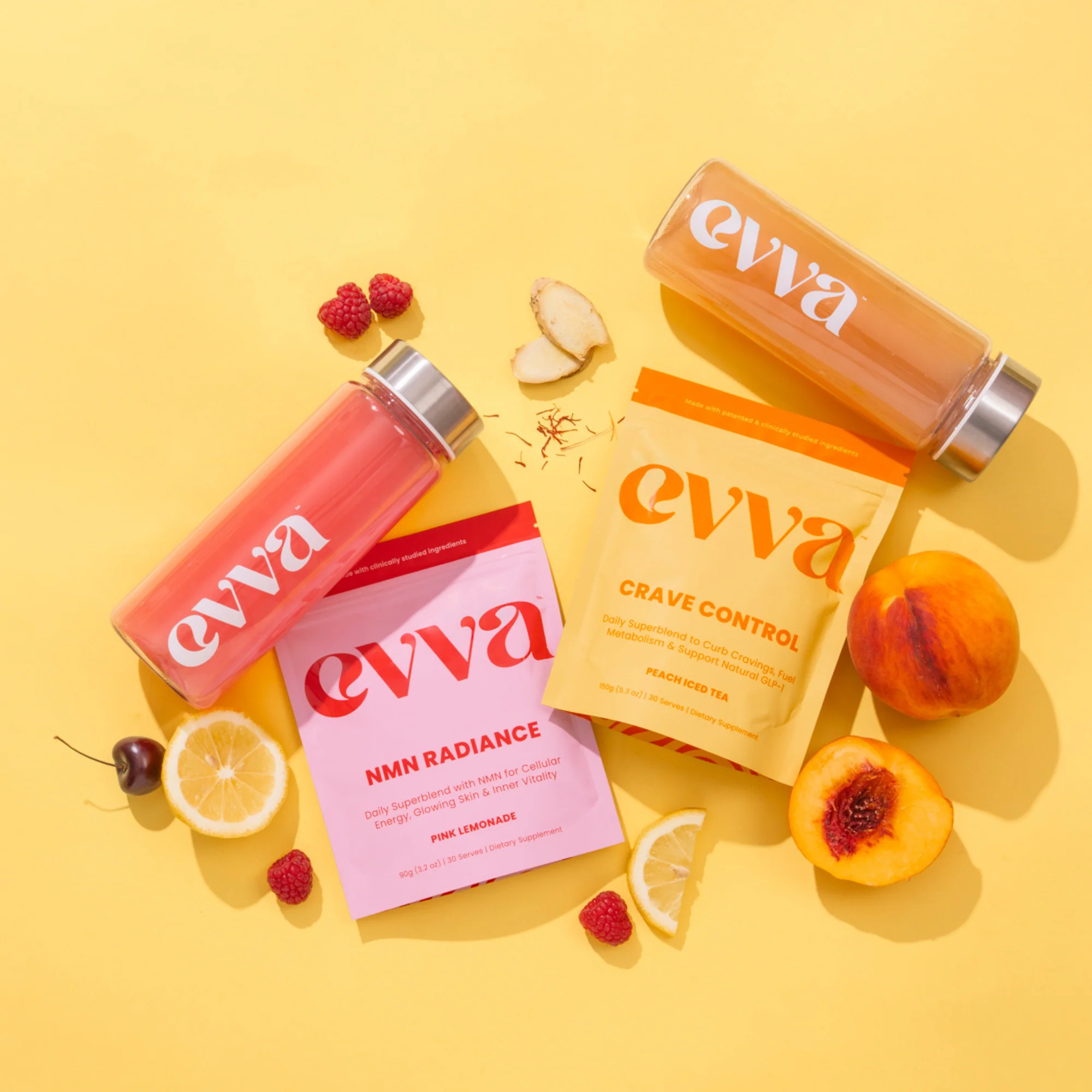 Evva_-_Product_Images_3 Assorted Eviva supplement pouches on a yellow surface with raspberries and citrus slices nearby.