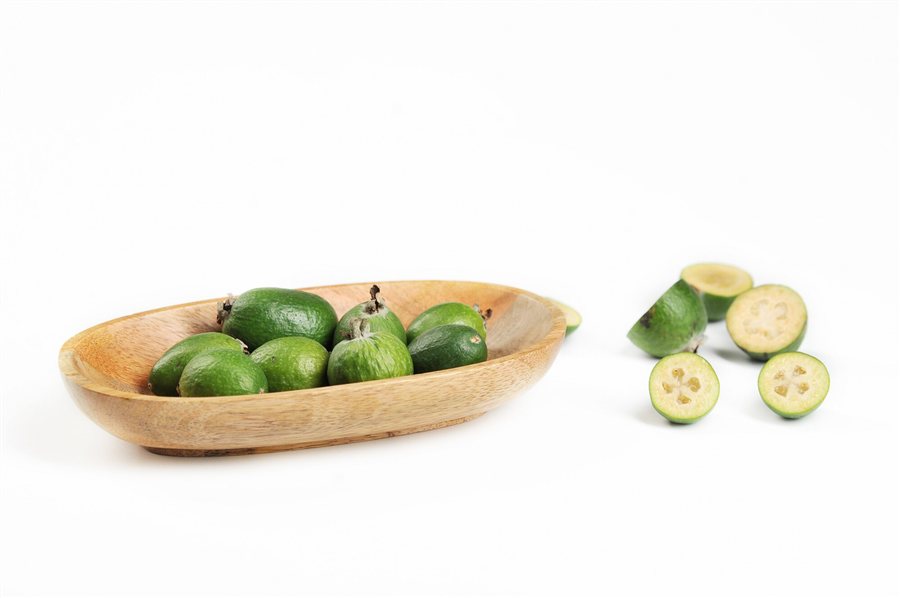 Whole and cut feijoa fruit Whole and cut feijoa fruit showing the flesh and seed cavity